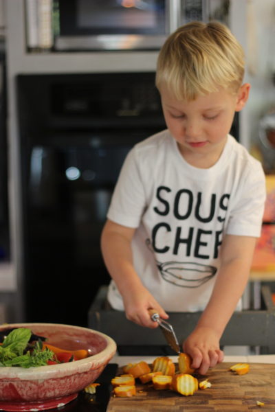 toddler chopping summer squash
